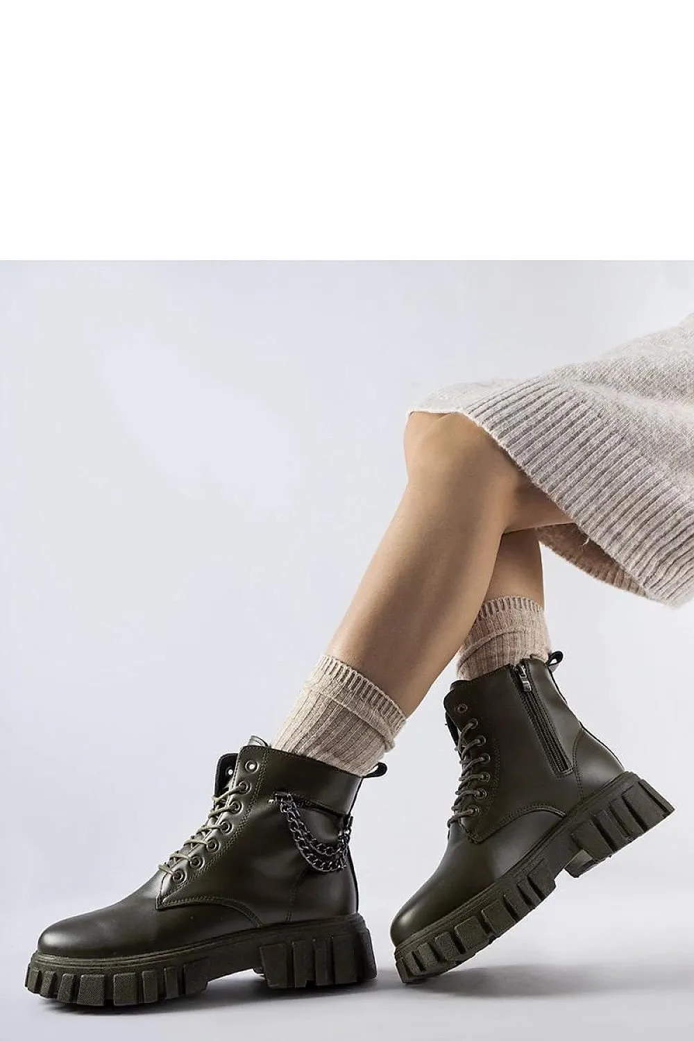 Dark green ankle boots with a pocket